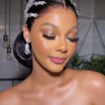 Woman wearing sparkling silver bridal headband and dangling diamond earrings with glamorous makeup.